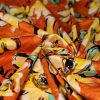 cotone rasatello elasticizzato arancio fiori gialli